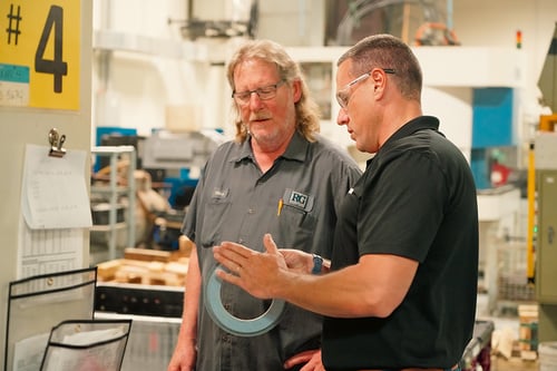 Weiler application expert discussing gear grinding parameters during a visit. 