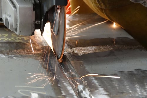 Tiger Ceramic combo wheel back gouging a steel plate to meet shipbuilding standards